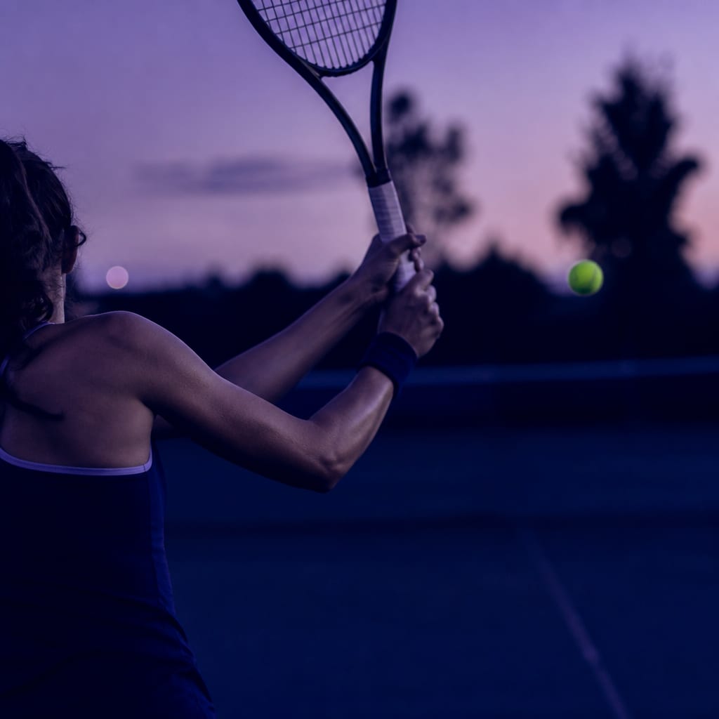 A two-handed backhand at the top of the preparation with the shoulders fully turned and the chin over the front shoulder