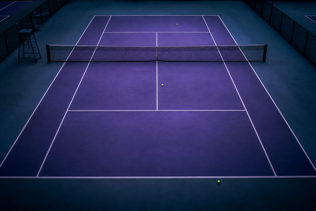 A singles court from overhead with three tennis balls marking deep, mid-court and short landing depths