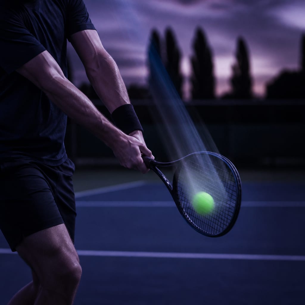 A backhand slice mid-swing with the racquet travelling from high to low and the face slightly open, showing the downward path across the ball